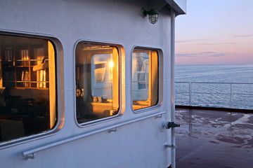 View of the sunset from the ship"s construction and navigational bridge. © masterskuz55