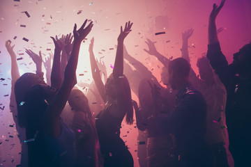 Photo of many birthday event people dancing colorful lights confetti flying enjoy nightclub hands...