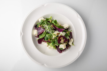 Nutritious, healthy, vitamin, dietary salad of boiled beets, cheese, arugula and nuts. Banquet...