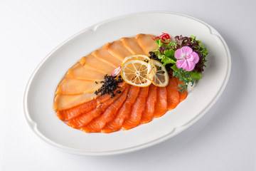 Snack from deli fish in the cutting. Salmon and white fish, perch and smoked eel. Banquet festive dishes. Gourmet restaurant menu. White background.