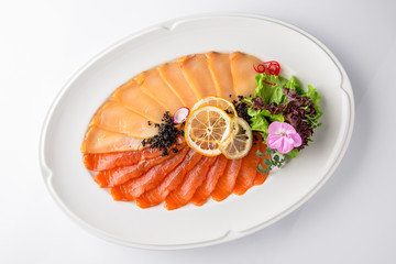 Snack from deli fish in the cutting. Salmon and white fish, perch and smoked eel. Banquet festive dishes. Gourmet restaurant menu. White background.