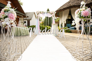 Wedding ceremony. Wedding arch and decoration with inscription ''Wedding''