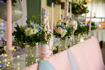 Wedding. Banquet. Table served with cutlery, flowers and crockery and covered with a tablecloth. Wedding decoration