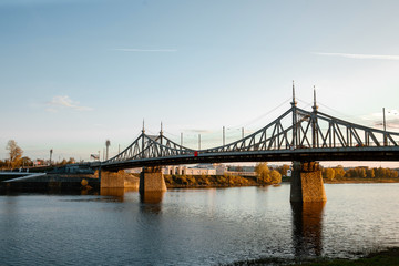 Fototapeta premium The old Volga bridge in Tver over the Volga river at sunset