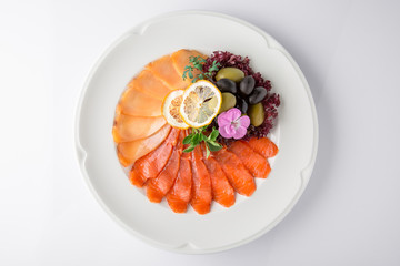 Snack from deli fish in the cutting. Salmon and white fish, perch and smoked eel. Banquet festive dishes. Gourmet restaurant menu. White background.