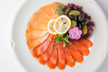 Snack from deli fish in the cutting. Salmon and white fish, perch and smoked eel. Banquet festive dishes. Gourmet restaurant menu. White background.