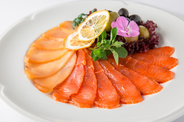 Snack from deli fish in the cutting. Salmon and white fish, perch and smoked eel. Banquet festive dishes. Gourmet restaurant menu. White background.