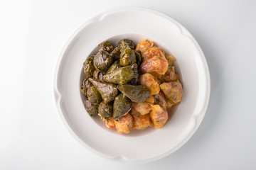 Dolma, rolls of cabbage and grape leaves with rice and meat. Banquet festive dishes. Gourmet restaurant menu. White background.