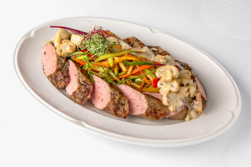 Slicing gourmet meat, pastrami, podcherevka, bastrum, beef and pork. Banquet festive dishes. Gourmet restaurant menu. White background.