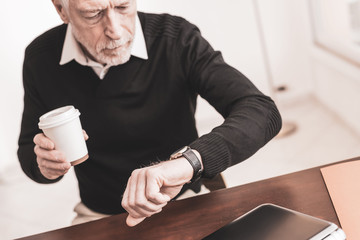 Businessman checking time on his wrist watch