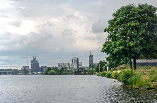 View along the banks of the river Maas towards the skyline of Roermond, The Netherlands with Saint Christoffer's cathedral and some more recent highrise