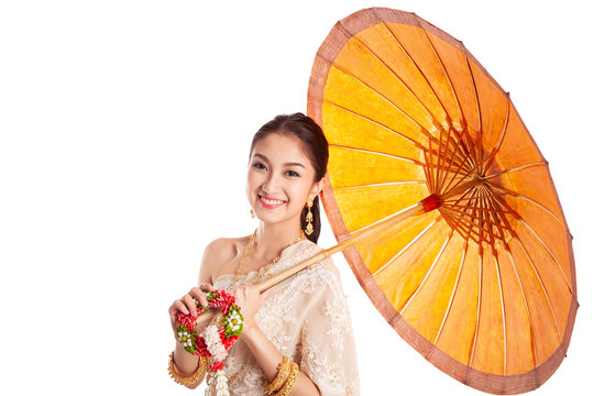 Thai asian women welcome with traditional Thai suit and umbrella isolated and white background, culture dressing costume concept