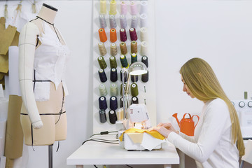 Dressmaker woman working with sewing machine