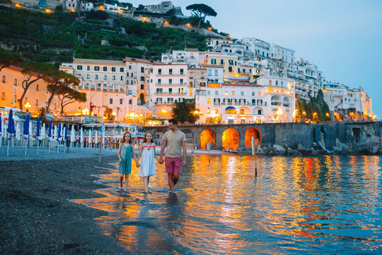 Fototapeta Adorable little girl on sunset in Amalfi town in Italy
