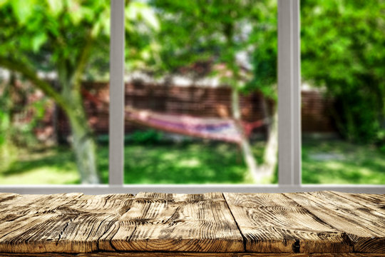 Table Background And Wooden Board And Garden Behind The Window