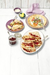 Two types of panckaes -  sweet (with jam) and savory (cream cheese, salmon) 