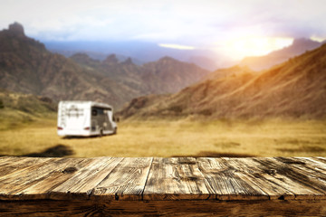 Table background and wooden board, and sunset and camper van