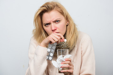 Woman taking pills. Medication and increased fluid intake. Unhealthy woman holding pills and water...