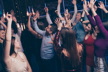 Nice-looking attractive glamorous cheerful glad positive stylish chic ladies and gentlemen having fun tradition dj set edm festal feast occasion in fashionable luxury place nightclub indoors