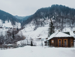a wooden house in winter landscape