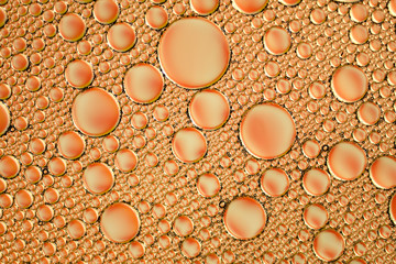 orange abstract background of soap bubbles on the water surface