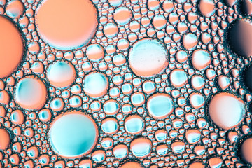 different size soap bubbles on the water surface