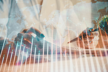 Financial chart drawn over hands taking notes background. Concept of research. Multi exposure