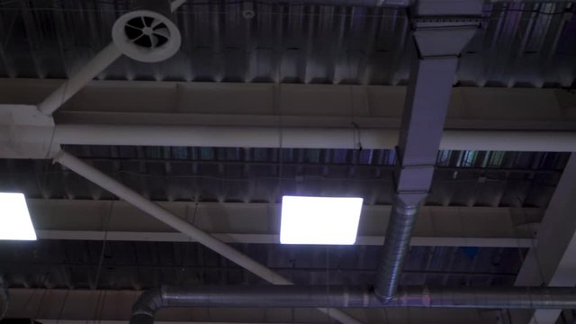 pipes of hvac system hang on ceiling of big mall