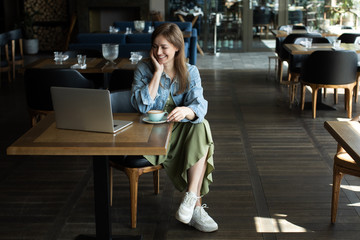 young girl drinking coffee and talking on the phone