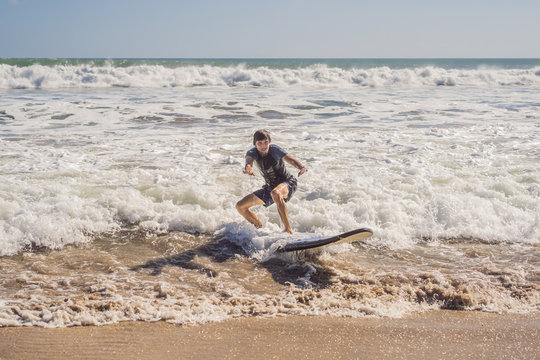 Surfer with his surfboard running to the waves