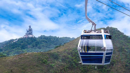 Hong Kong cable car over green mountain with Giant Buddha statue 1
