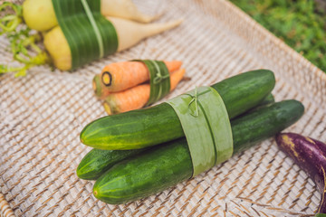 Eco-friendly product packaging concept. Vegetables wrapped in a banana leaf, as an alternative to a plastic bag. Zero waste concept. Alternative packaging