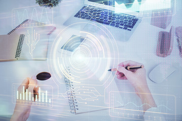 Double exposure of writing hand on background with data technology hologram. Big data concept.