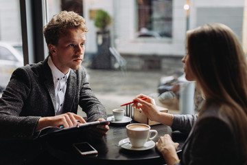 Young businessmen having a meeting in a cafe