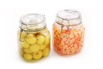 Carissa carandas or Carunda and Indian gooseberry preserved in syrup on white background. Preserved fruits for good taste.