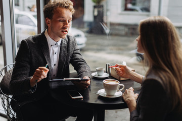Young businessmen having a meeting in a cafe