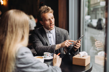 Young businessmen having a meeting in a cafe