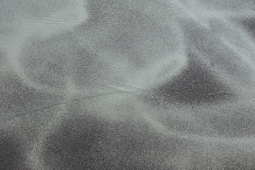 Splashed silver paint on a black wall