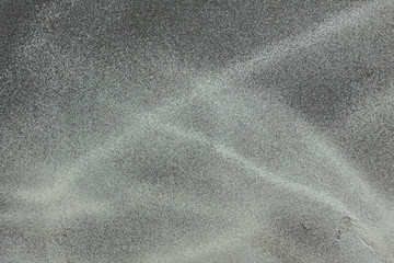 Splashed silver paint on a black wall