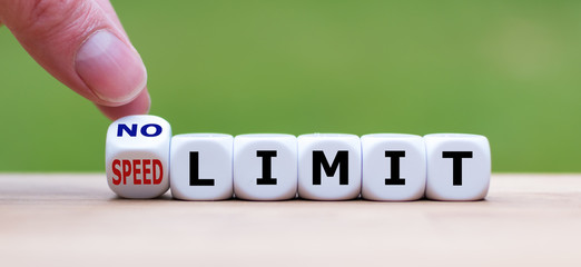 Hand turns dice and changes the expression "speed limit" to "no limit" (or vice versa).