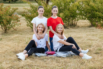 Fototapeta premium Group of schoolchildren twins laughing and embracing