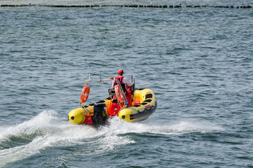 Fototapeta na wymiar LIFEBOAT - The rescuer patrols the holiday bathing resort on the sea coast