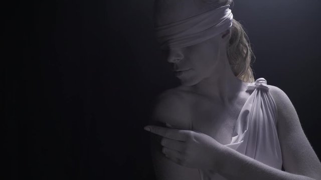 Close up of Themis marble statue is posing and touching her shoulder, 4k
