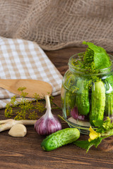 pickled cucumbers on a wooden background