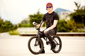 Rider on BMX serious portrati with sunglasses and snapback cap