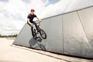 Extreme BMX Wallride in casual black clothes