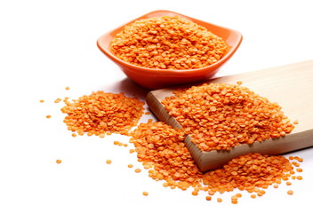 Red lentils with bowl and wooden chopping board
