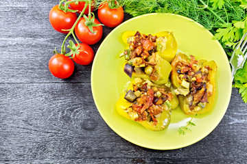 Pepper stuffed with vegetables in green plate on board top