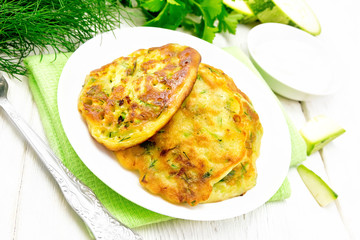 Pancakes of zucchini on white board
