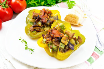 Pepper stuffed with vegetables in plate on board
